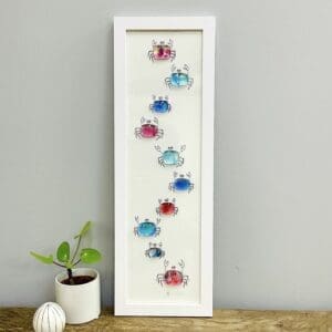 Framed fused glass crabs on framing glass, multiple colours